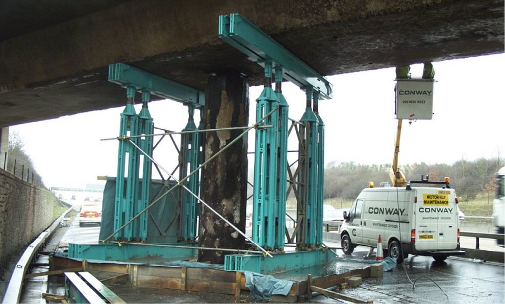 Temporary propping lifting and supporting a busy motorway bridge from collapsing while construction work goes on to strengthen the bridge